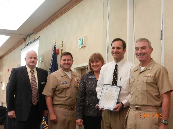 In October, Neil Bourassa (l), Lt. Cmdr. David Pereira, USN (2nd from l), chapter vice president for military affairs, and Teresa Duvall, chapter president, present Michael Kimener (2nd from r) with the Civilian Cyber Professional of the Month Award as Adm. Russell stands witness.